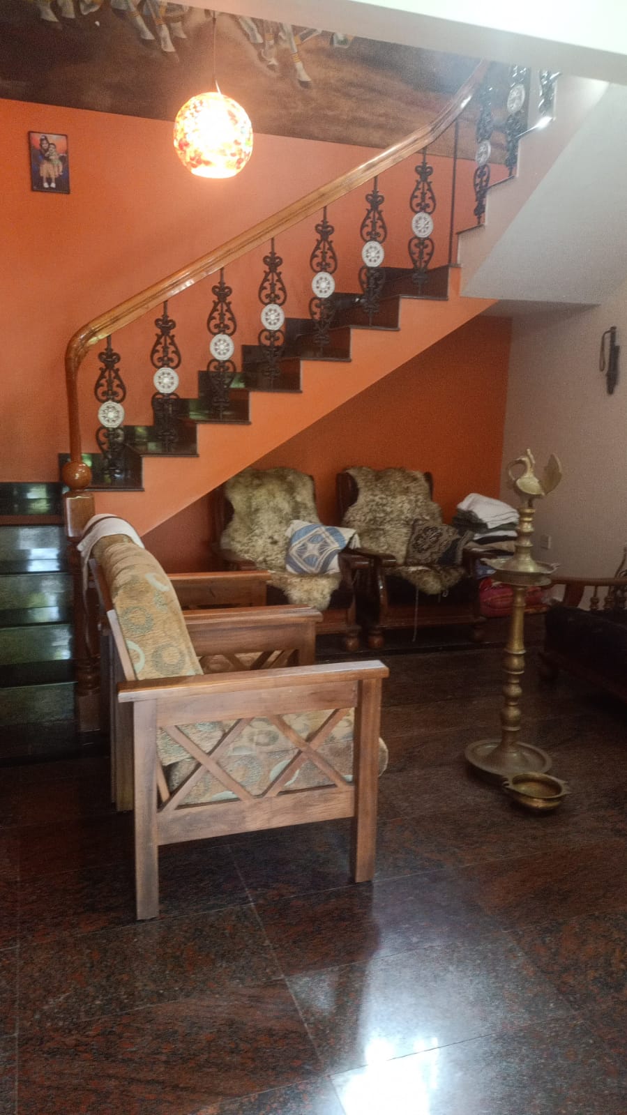 Spacious common living area with traditional Kerala seating